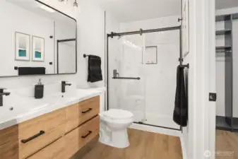Fully remodeled primary bath with double sinks and walk-in shower.