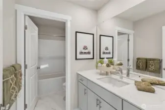 Hall bathroom upstairs features double doors to let more than one person use it at once for those busy mornings. Photo is representational. Colors and finishes may vary. See site agent for details.