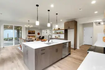 Slab quartz countertops and backsplash, GE Profile appliances, soft close cabinetry, and upscale lighting are just some of the great features of this kitchen.