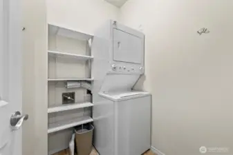 Laundry room with extra space for storage. Stackable washer and dryer do convey.