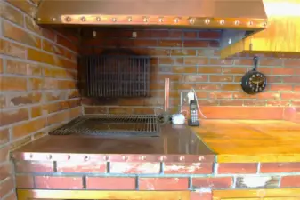 Kitchen has custom copper vent and accents of cooper throughout with double ovens