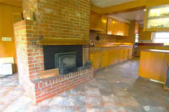 second fireplace off of kitchen and into dining room or den space