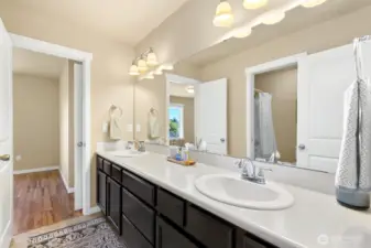 Jack in Jill bath offer double vanities, good storage and private shower / toilet room. Entrance to adjoining bedroom at far side.