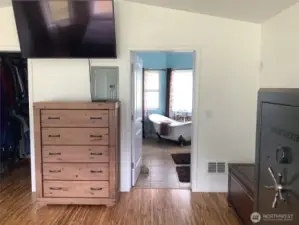Entry into large bathroom with clawfoot tub and tile flooring