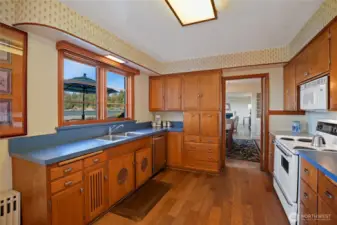 A baker's dream kitchen, complete with proofing cabinets and marble slab counter left of the stove.