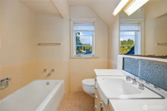 Main bath upper level with tub and separate shower.