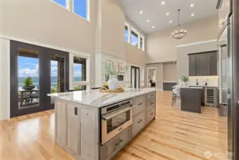 Open Kitchen & Living Space w/ Electric Fireplace. Cambria Skara Brea Kitchen Countertops, Viking appliances, custom soft-close cabinets & drawers w/ inserts & under cabinet lighting.