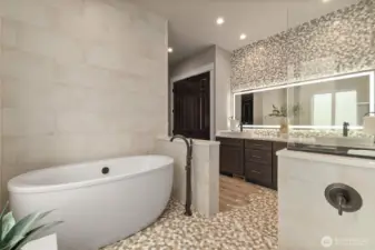 Main floor primary suite  5 piece bath w/ Pental Stella Claudis Quartz Countertops, Soaking Tub, Dual-Shower Heads, Double Vanity, Towel Warmer & "Closet by Design" Walk-in Closet. All Bathrooms w/ Amorho LED Lighting Mirrors.