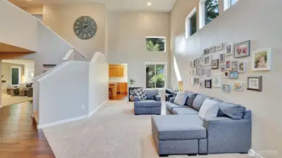 Enter to this bright and airy living space with soaring ceilings and a seamless flow into the kitchen and adjacent rooms.