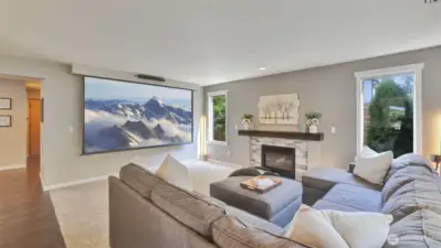 You will love having the option for a wall mounted TV or enjoying a movie at home on the projector in this versatile living room, plus this projector stays!