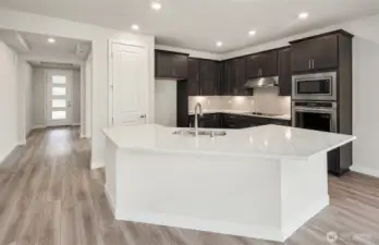 Kitchen finishes vary per home. Photo of same design, not this specific house.