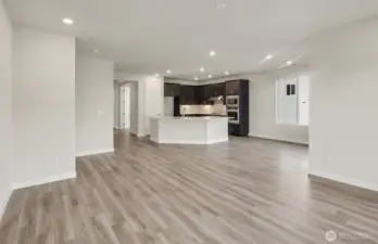 Spacious living room. Kitchen finishes vary per home. Photo of same design, not this specific house.