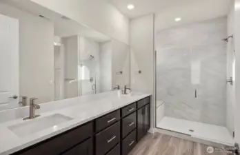 Bathroom finishes vary per home. Photo of same design, not this specific house.