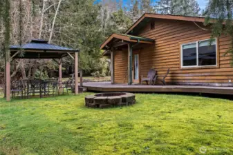 Deck on the side of the house and fire pit.