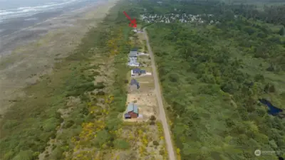Existing homes are built on the primary dune on the west side of Dunes Lane.  Arrow indicates approximate location of building site.