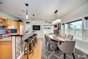 You can't help but smile when you enter the cheerful kitchen with its custom tiled island + huge breakfast bar.