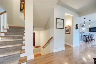 Stairs leading up and down stairs.  Main floor powder room is in alcove.