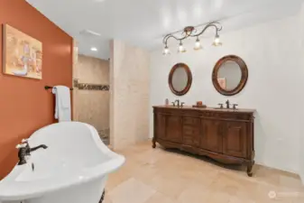 Primary ensuite features a large clawfoot tub, dual vanities, and beautiful walk in shower.  A separate toilet room has a linen closet with great storage.