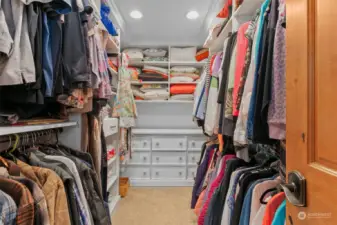 Large walk in closet with custom storage shelves.