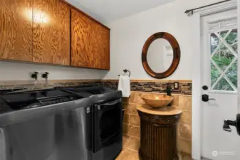 The laundry room is combined with a 3/4 bath. Convenient access  to the backyard is perfect for after a swim or gardening.