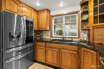 Instant hot water tap at sink.  Window brightens the kitchen and looks out at the colorful front yard landscape.