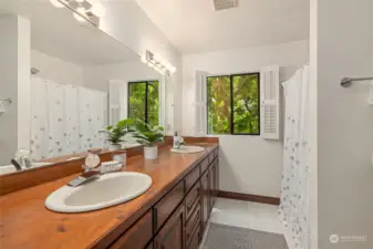 A full bath on the main floor with dual sinks, tub/shower.