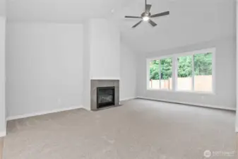 Living room is light and bright  and features a cozy gas fireplace.