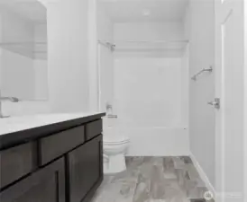 Conveniently accessible, the 1st full bathroom is located between front bedroom and den.