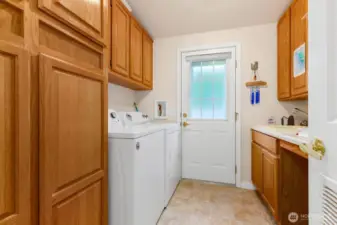 Full-size laundry room with side yard access.