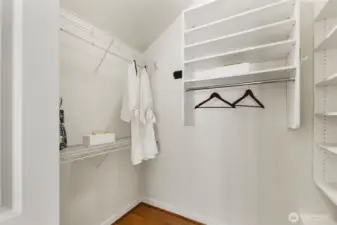 Massive walk in closet with custom closet system.