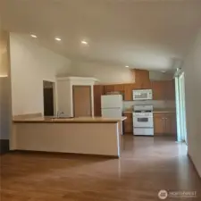Kitchen with eating bar open to large dining/living area