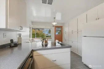 Kitchen facing west and looking through breakfast nook area. Look at that storage!
