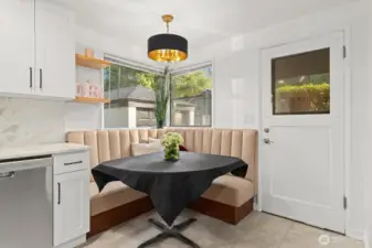 built-in banquet with new lighting fixture and access to the exterior