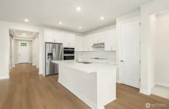 Kitchen space, looking down hallway to front door
