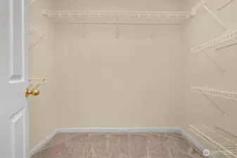Primary bedroom walk in closet
