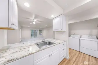 Kitchen of Unit #1 - Opened closet doors showing washer/dryer (all new)