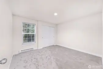 Unit #1 - Bedroom 2 of 2.  Window looks out to green space.