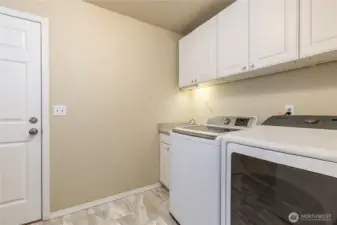 Utility room provides access to the garage. Note the convenient utility sink and under-cabinet lighting!