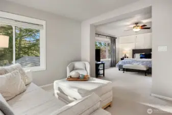 Primary sitting room looking into the bedroom.