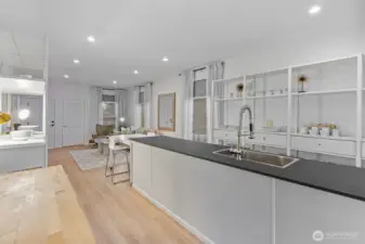 Kitchen features high-end German Poggenpohl cabinetry, stainless steel appliances; induction range, Viking refrigerator, and locally sourced, Tacoma-made Richlite countertops—durable, eco-friendly, and crafted from FSC®-certified paper and resin.