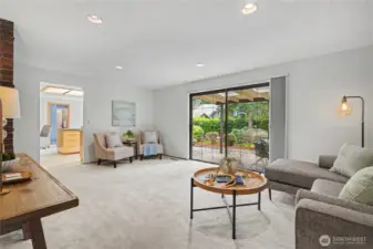 Comfortable living area with large sliding glass door providing direct access to the covered patio and backyard.