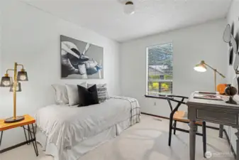 Flexible main-level room suitable for a bedroom or office, featuring natural light and neutral finishes.