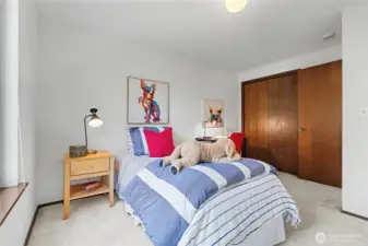 Well-sized bedroom with neutral walls, ample natural light, and functional layout for guests or everyday use.