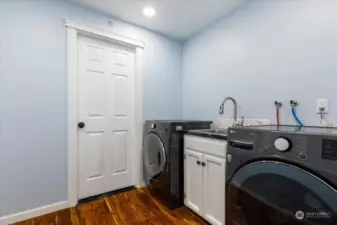 Utility room with deep sink and access to the garage.