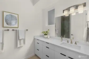Primary bathroom features a walk-in ceramic tile shower and white quartz countertop.