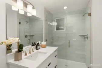 First floor bathroom features a walk-in ceramic tile shower and a quartz vanity.