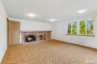 Family Room with wood-burning fireplace and wood box with chute access from garage