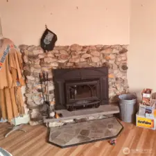 Main floor living room with wood burning stove will comfortably heat entire living/kitchen area