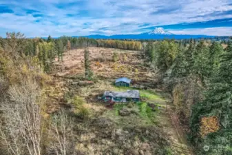 Looking from West to East. Property may have Mountain view on clear day. Treeline is a good approximate property line.  R10 zoning  Lot 435,600sq. ft. Value in the Barn and the Land.  House can be saved, serious investor only.