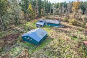 Looking from East to West.  Barn is in very good shape Dry and a lil clean up and ready to use.  Back elevation of the house shows the daylight basement.  Enclosed sun porch looks like it is still viable and needs a little tlc.